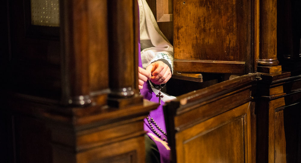 Priest Sitting in Confession Booth